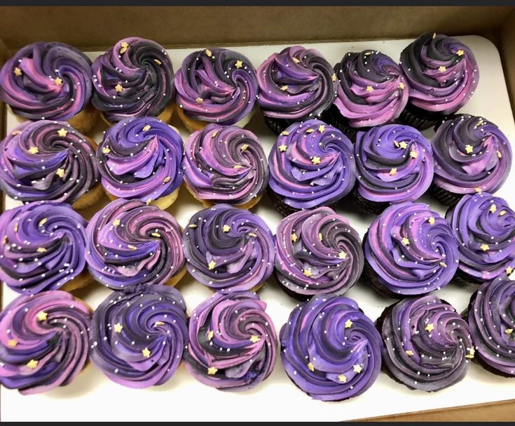 purple cupcakes with gold sprinkles in a box