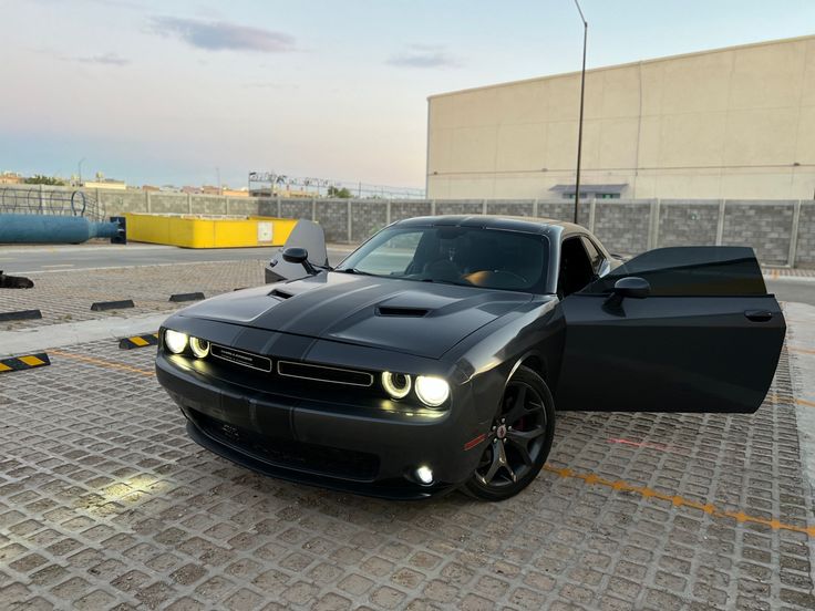 a black sports car parked in front of a building