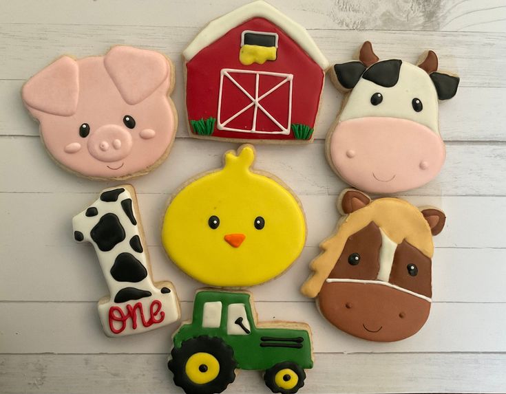 decorated cookies with farm animals and farm animals on them are arranged next to each other