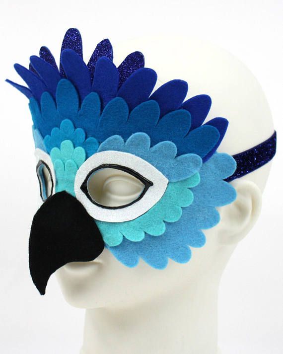 a blue and white bird mask on top of a head