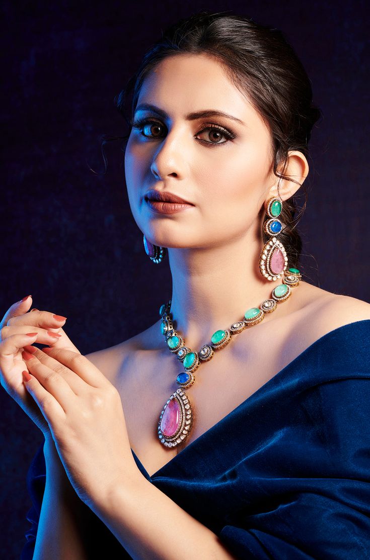 Elegantly blending classic and contemporary styles, this necklace set exudes a timeless and regal presence that is sure to capture attention. Perfect for any special occasion, its combination of traditional charm and modern elegance makes it the perfect accessory to elevate your ensemble. Finish: 22KT Gold Plating Material: Silver, Copper Alloy, Polki, Crystals Color: Multicolored Size: Free Size, Adjustable Closure Type: Draw String Box Contains: 1 Necklace, 1 Pair Earrings Elegant Bridal Necklace With Detachable Pendant, Elegant Bridal Necklace With Detachable Pendant For Wedding, Elegant Multicolor Necklaces For Formal Occasions, Formal Temple Jewelry Kundan Necklace With Matching Earrings, Elegant Multicolor Gemstone Temple Necklace, Elegant Multicolor Jeweled Necklaces, Elegant Jewelry Sets With Intricate Pendant Design, Elegant Temple Necklace With Jewels, Elegant Kundan Jewelry Sets For Formal Occasions