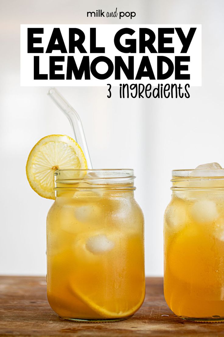 two mason jars filled with lemonade on top of a wooden table