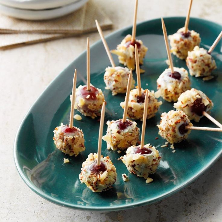 small appetizers with toothpicks on a green plate