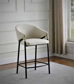 a bar stool with a white upholstered seat and black legs in front of a window