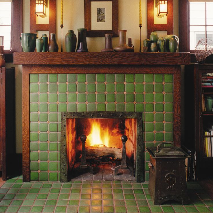 a fireplace in a living room filled with furniture and bookshelves next to a fire place