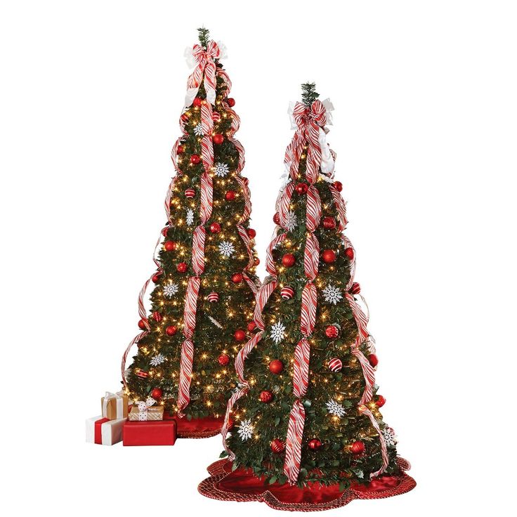 two christmas trees decorated with candy canes and bows are shown in front of a white background