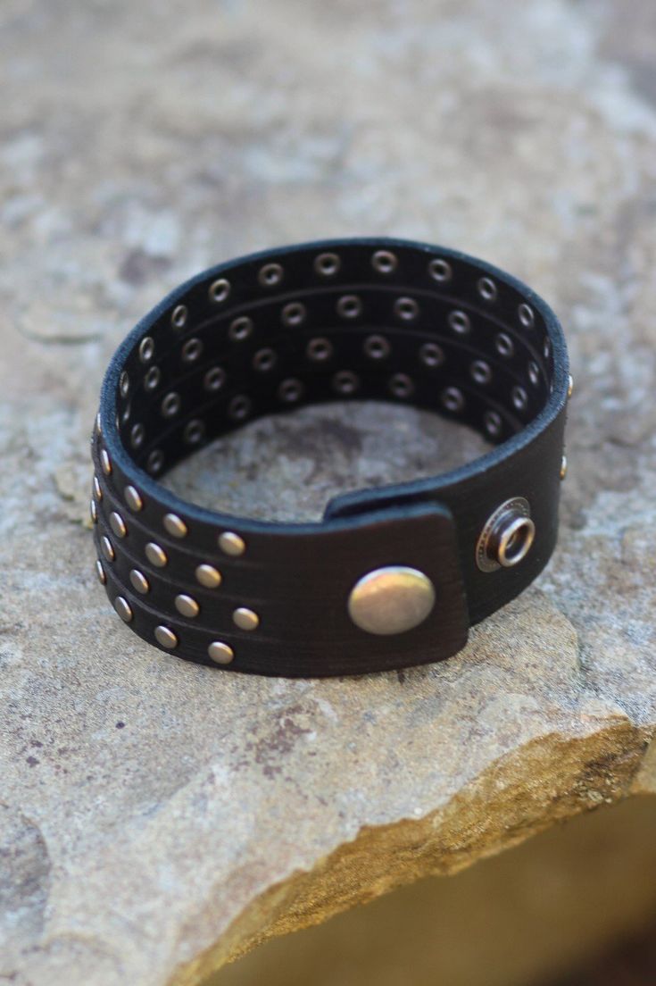 This studded cuff gives the illusion you are wearing four studded bracelets! -Color: Black -Handmade -Genuine leather -Measurements: 9"L -Imported Edgy Black Cuff Bracelet With Rivets, Adjustable Punk Cuff Bracelet With Rivets, Punk Adjustable Cuff Bracelet With Rivets, Punk Style Adjustable Cuff Bracelet With Rivets, Punk Cuff Bracelets With Rivets, Edgy Adjustable Cuff Leather Bracelet, Punk Black Bracelet With Silver Studs, Black Leather Punk Bracelet With Silver Studs, Edgy Black Cuff Bracelet For Festival