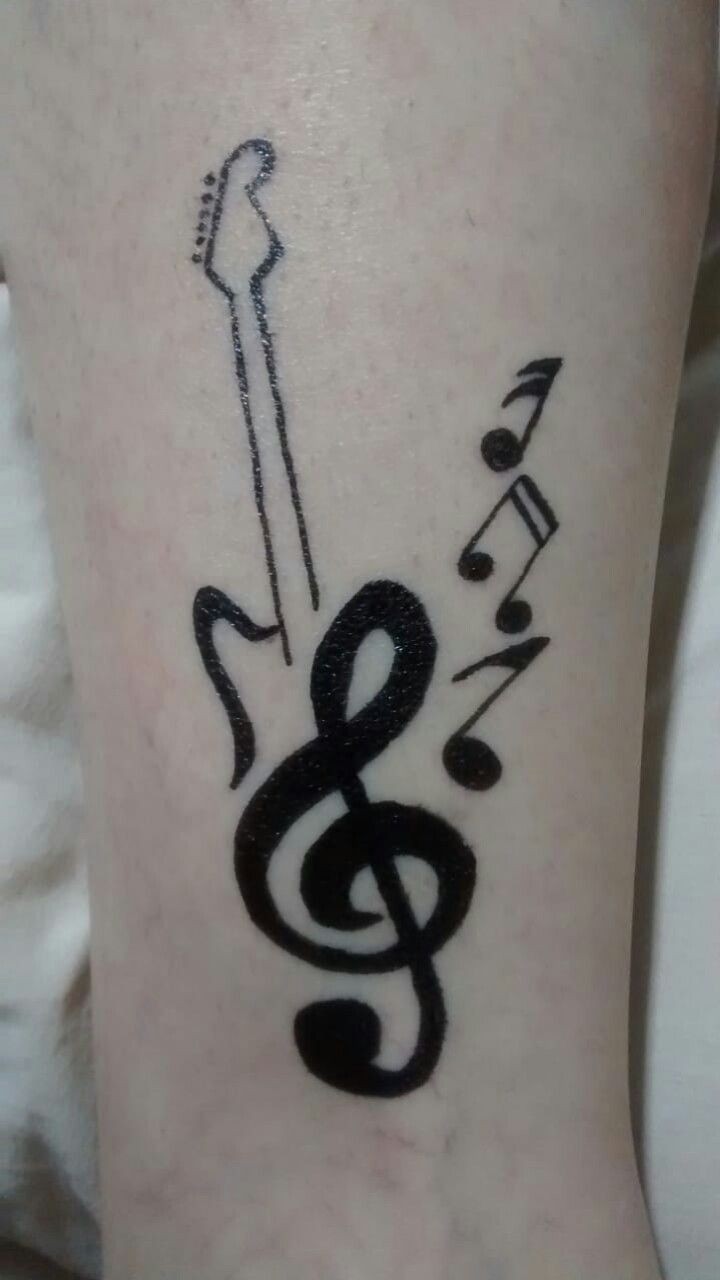 a tattoo with musical notes on it