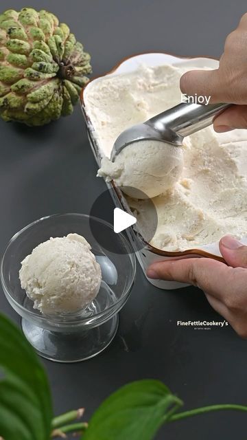 a person scooping ice cream from a container