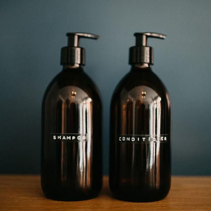 two brown bottles sitting on top of a wooden table