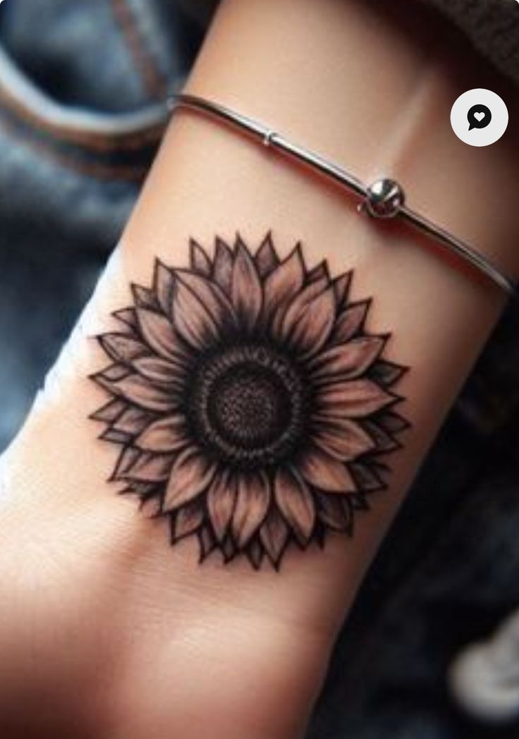 a sunflower tattoo is shown on the wrist