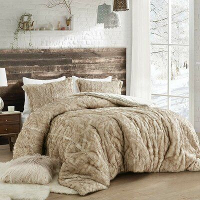 the bed is made up with fur and pillows