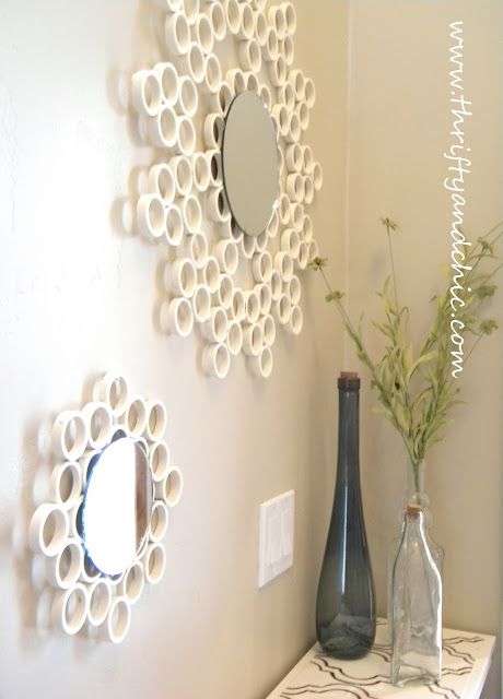 two vases are sitting on a shelf in front of a mirror and wall decoration