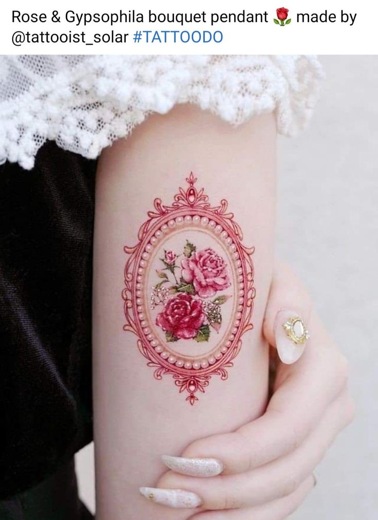 a woman's arm with a rose tattoo on the left side of her arm