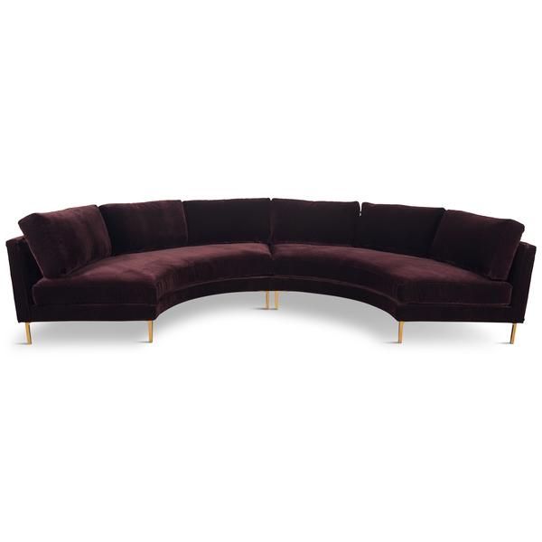 the curved sectional sofa has gold legs and dark purple velvet upholstered with brass