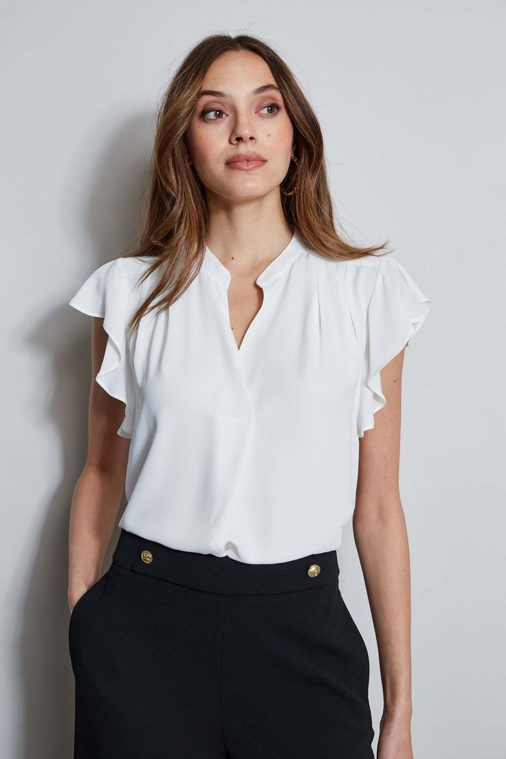 The soft cap sleeves lend a femme twist to this luxe georgette top. With its contour pleat detail neckline, it is perfect for layering with your favorite blazer or wearing on its own. T-Tahari Short Sleeve V-Neck Top Runs true to size. Model is 5'9" and wearing size S Dry Clean Only Imported Style #: THF44013 Flattering Fitted Tops For Workwear, Elegant Flutter Sleeve Tops For Spring, Elegant Spring Tops With Flutter Sleeves, Fitted Ruffle Sleeve Blouse For Office, Elegant Flutter Sleeve Ruffle Tops, Elegant Fitted Tops With Cap Sleeves, Elegant Sleeveless Tops For Business Casual, Chic Solid Color Blouse With Flutter Sleeves, Chic Solid Color Flutter Sleeve Tops