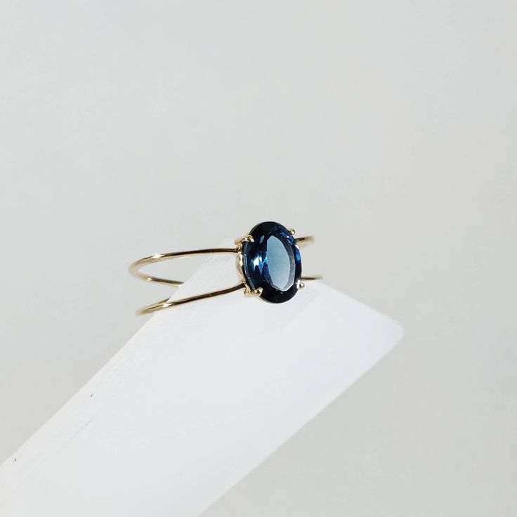 **KINDLY CHECK OUT THE VIDEO OF THE ITEM FOR A CLEARER VIEW**Details of the ring Gem: London Blue topaz Gem size: 8×6 mm Gem shape-Oval Gem weight: 1.45 carats Gold purity: 14KT (58.33% approx.) Gold weight: 1.03 Grams total weight of ring:1.32 Grams emerald cut london blue topaz gemstones set in solid 14KT yellow gold. The Gold purity is guaranteed and it comes with authentic 14 kt gold hallmark. Since these Rings are handmade, Size Customization is available for this ring and it is available i Modern Blue Sapphire Ring In 14k Gold, Modern 14k Gold Topaz Birthstone Ring, Modern 14k Gold Topaz Ring With Prong Setting, Modern Topaz Ring In 14k Gold With Prong Setting, Modern Blue Topaz Ring In 14k Gold, Modern 14k Gold Oval Topaz Ring, Dainty Rings, Alternative Engagement Ring, Emerald Ring Gold