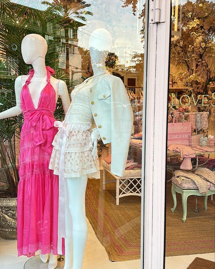 two mannequins dressed in pink and white dresses are standing next to each other