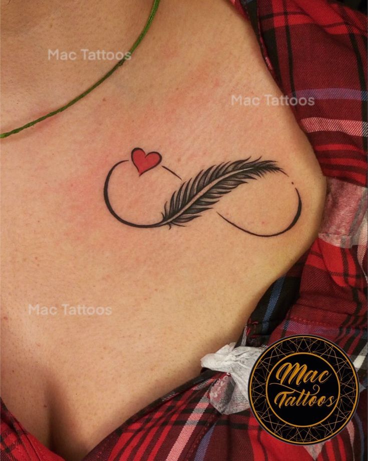 a woman's chest with a feather and heart tattoo on the left side of her stomach