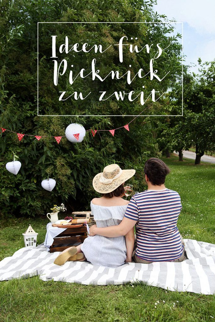 two people are sitting on a blanket in the grass with a sign that says, when fun picknickk zu zweit