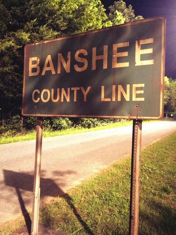 a street sign that reads banshee county line on the side of a road