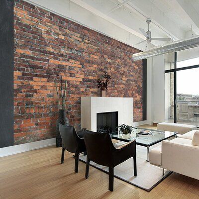 a living room filled with furniture and a fire place in front of a brick wall