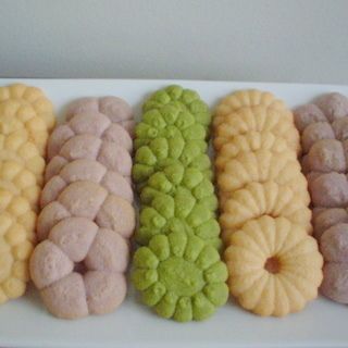 a white plate topped with different colored donuts