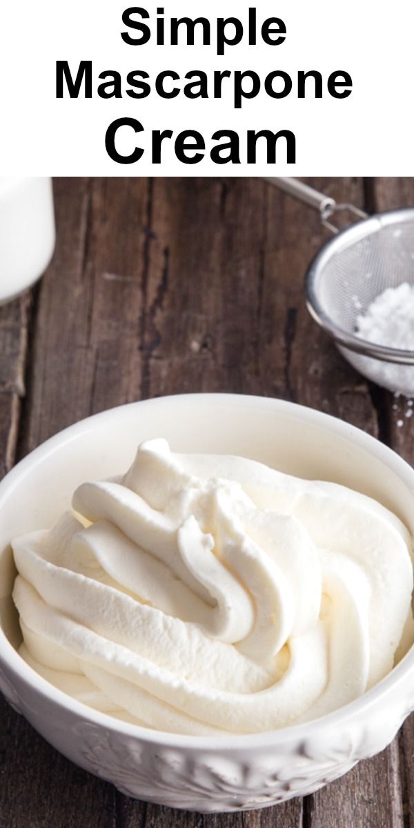 a bowl filled with whipped cream on top of a wooden table