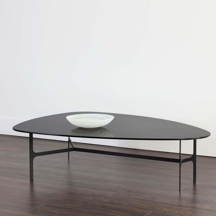 a black coffee table with a bowl on top