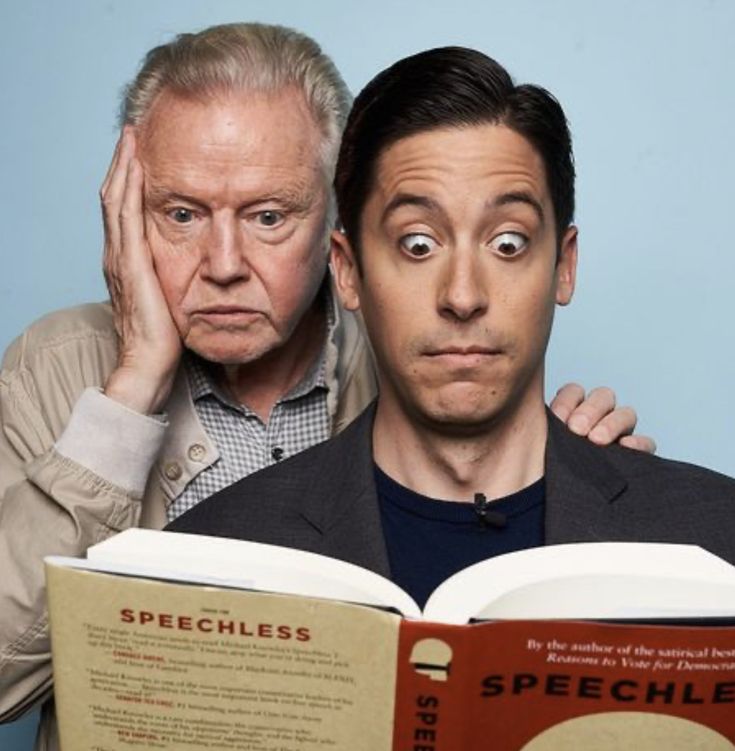 two men looking surprised while reading a book