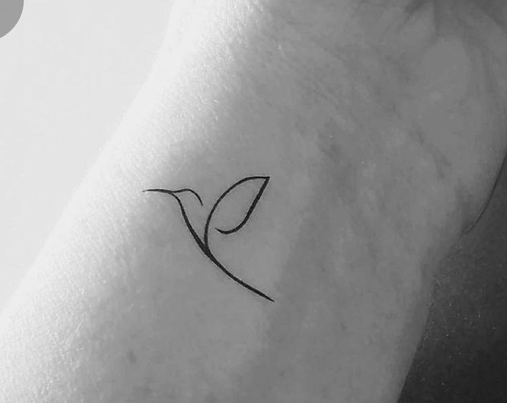 a small bird tattoo on the wrist