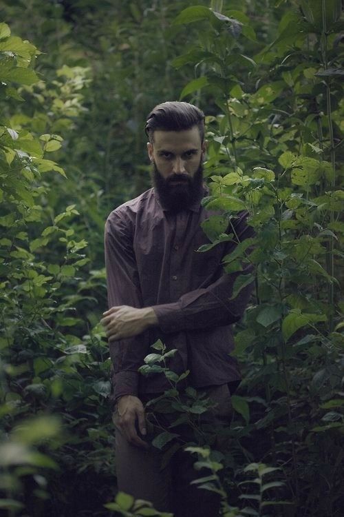 a man standing in the middle of a forest