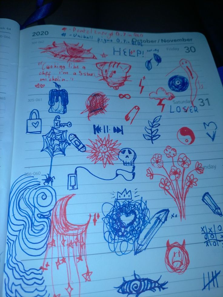 an open notebook with drawings on it and writing in red, white and blue ink