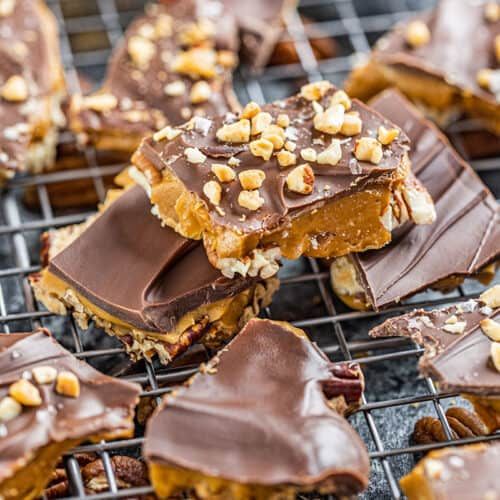 several pieces of chocolate and nuts on a cooling rack