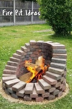 a fire pit made out of bricks in the grass