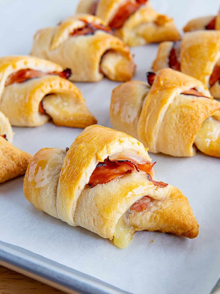 ham and cheese crescent pastries on a baking sheet