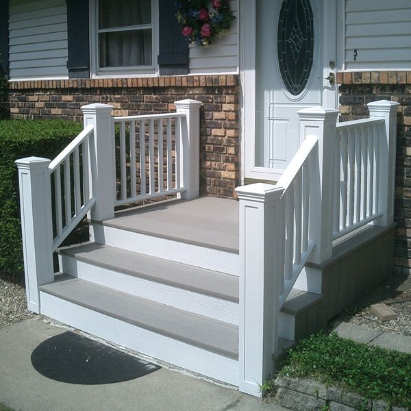 a white porch with steps leading up to the front door and side entry area on a brick house