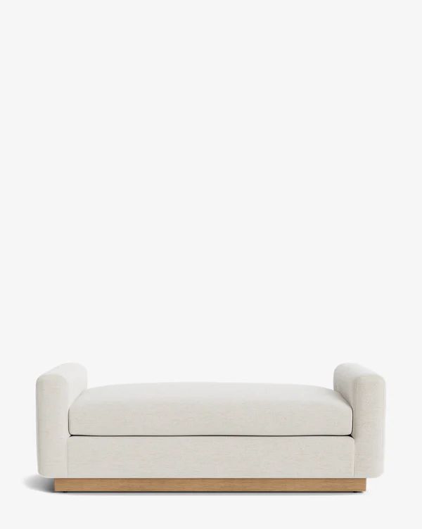 a white couch sitting on top of a wooden frame