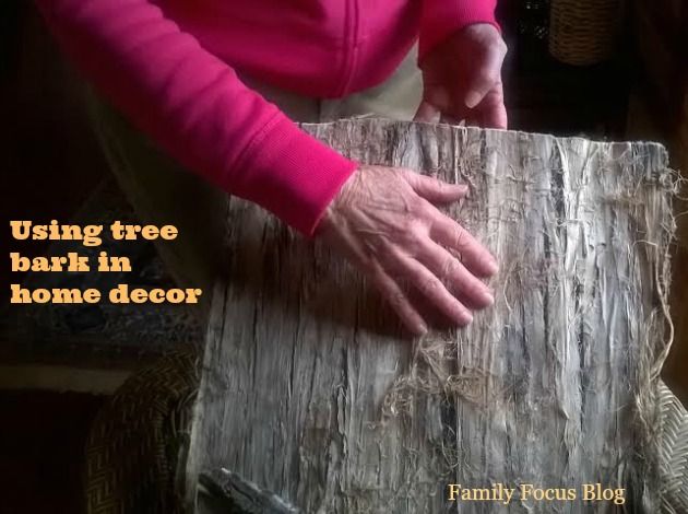 an old woman is making a tree bark home decor project with her hands on top of it