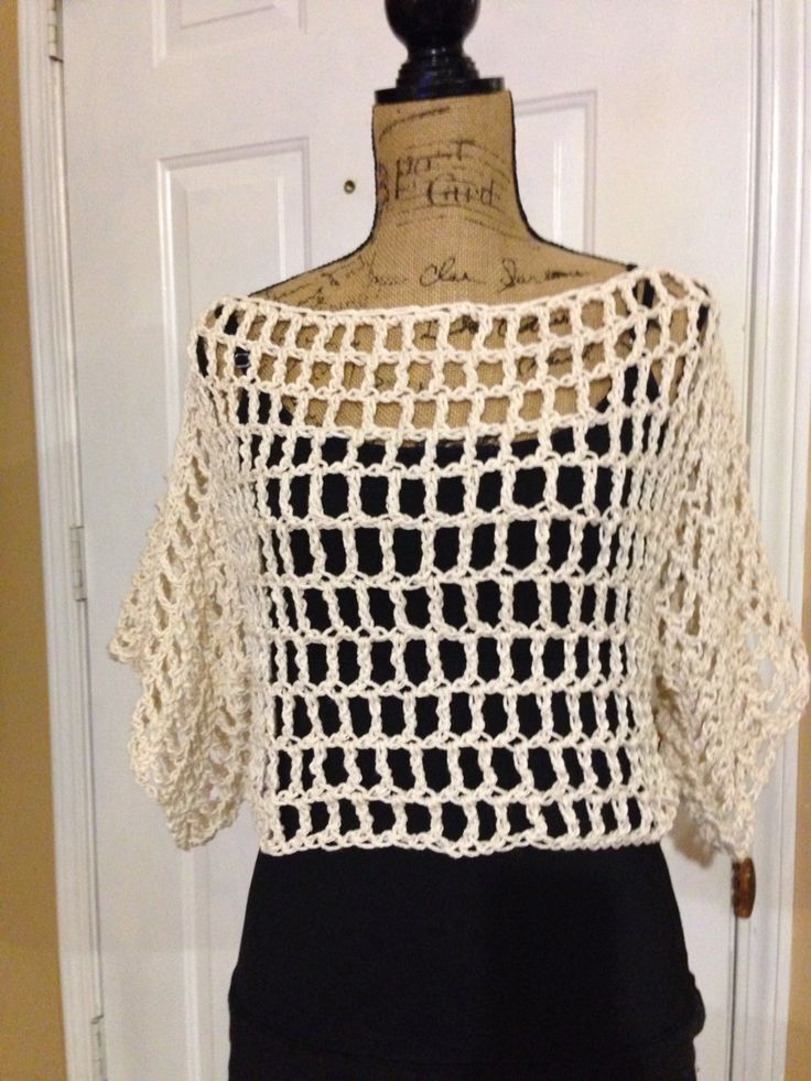 a crocheted top is displayed on a mannequin