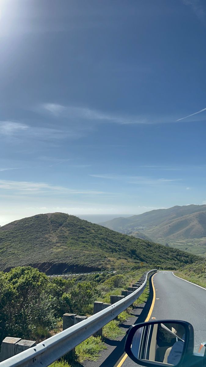 Car driving down a road that goes over pretty hills in california Pretty Road Aesthetic, Road Trip Aesthetic Mountains, Driving In La Aesthetic, California Hills Aesthetic, Highway Aesthetic Day, Hidden Hills Aesthetic, Mountain Road Trip Aesthetic, California Mountains Aesthetic, Mountain Road Aesthetic