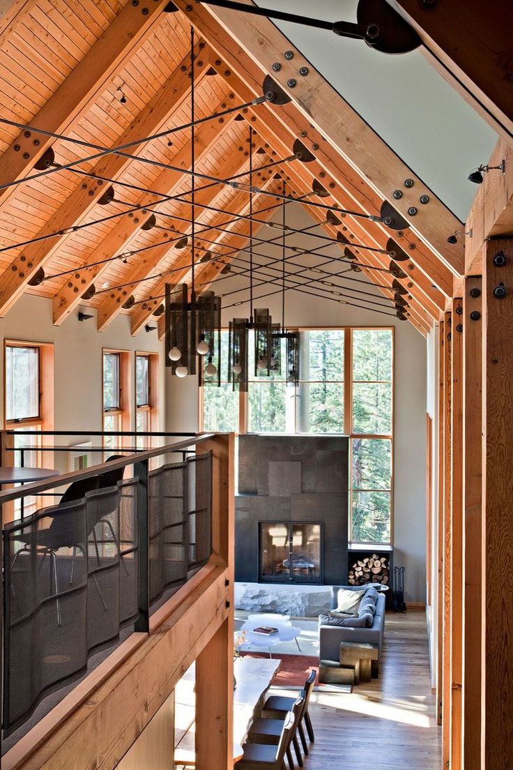 a living room filled with furniture and a fire place in the middle of a building