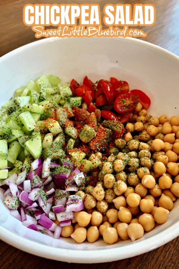 chickpea salad in a white bowl on a wooden table