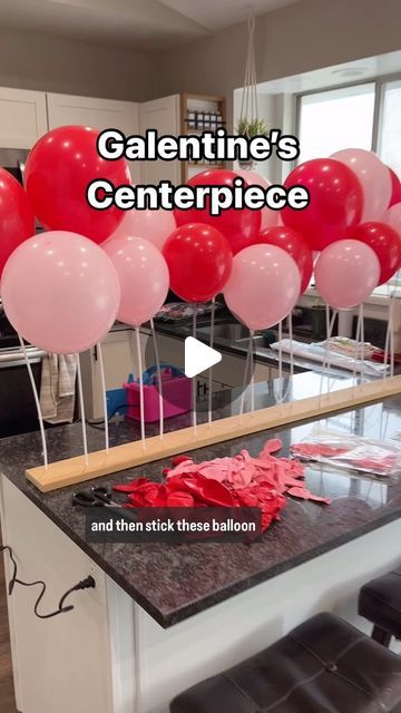 balloons and sticks sticking out of the counter in front of a kitchen island with text overlay that reads, valentine's centerpiece