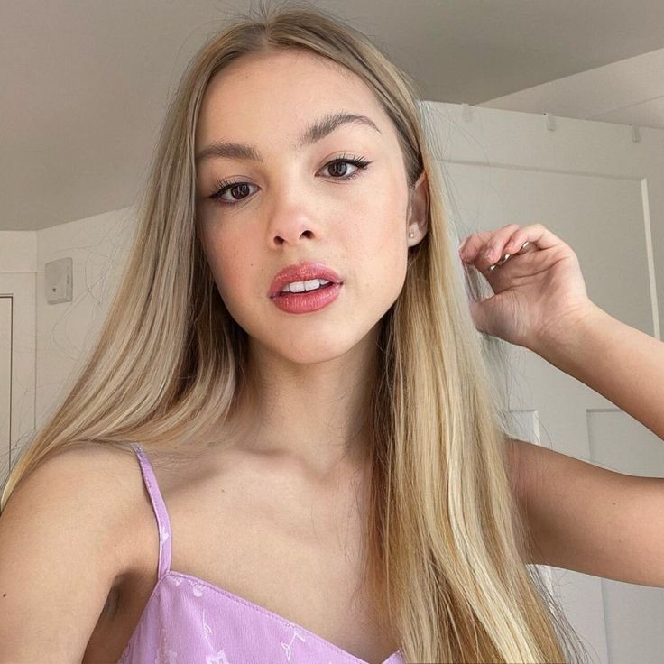 a young woman brushing her long blonde hair