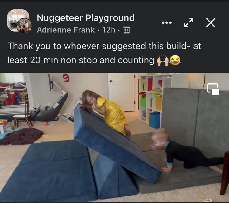 two children are playing in a playroom and one child is on the floor with his head down