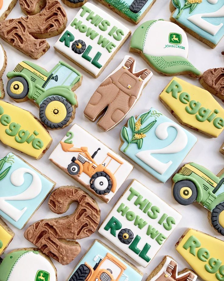 there are many decorated cookies with tractors and farm animals on them, all in different colors