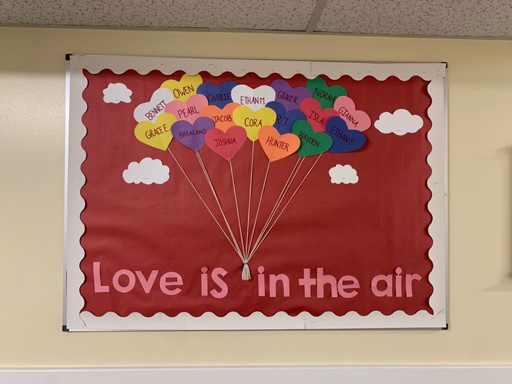 a bulletin board with hearts and words on it that says love is in the air