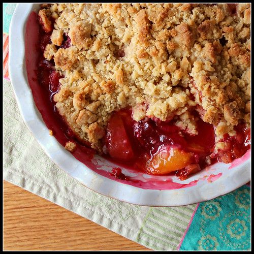 a close up of a pie in a bowl on a table with a napkin and fork