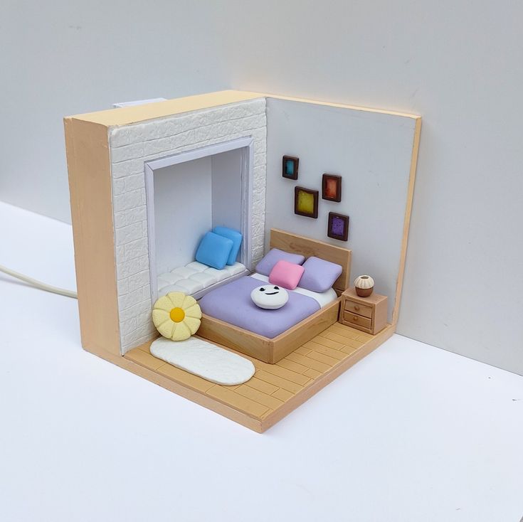 a dollhouse made to look like a bedroom with a bed and nightstand in it